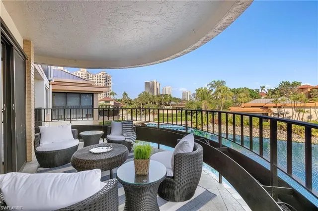a roof deck with couches and potted plants