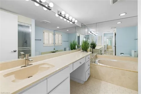 a bathroom with a sink double vanity and a mirror