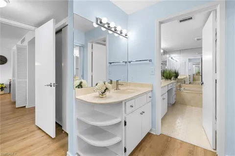 a spacious bathroom with a shower sink and mirror