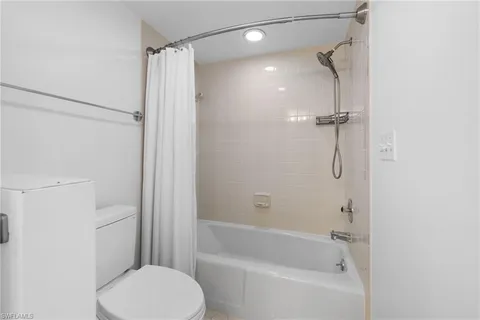 a roof deck with couches and potted plants