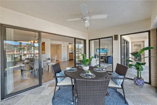 a view of a dining room with furniture large windows and wooden floor