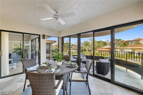 a view of a balcony with chairs and a table