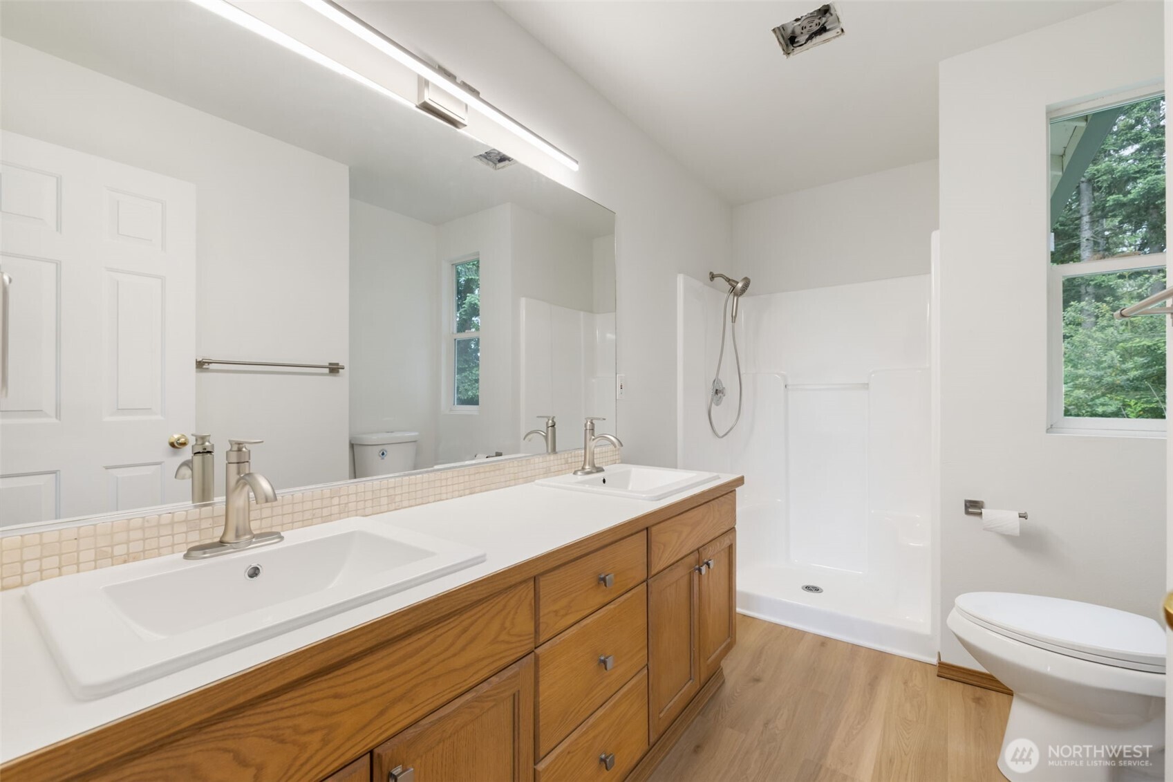 3560 Courtyard Lane Bremerton, WA 98310 - Photo 14 of 26 a spacious bathroom with a double vanity sink toilet mirror and bathtub