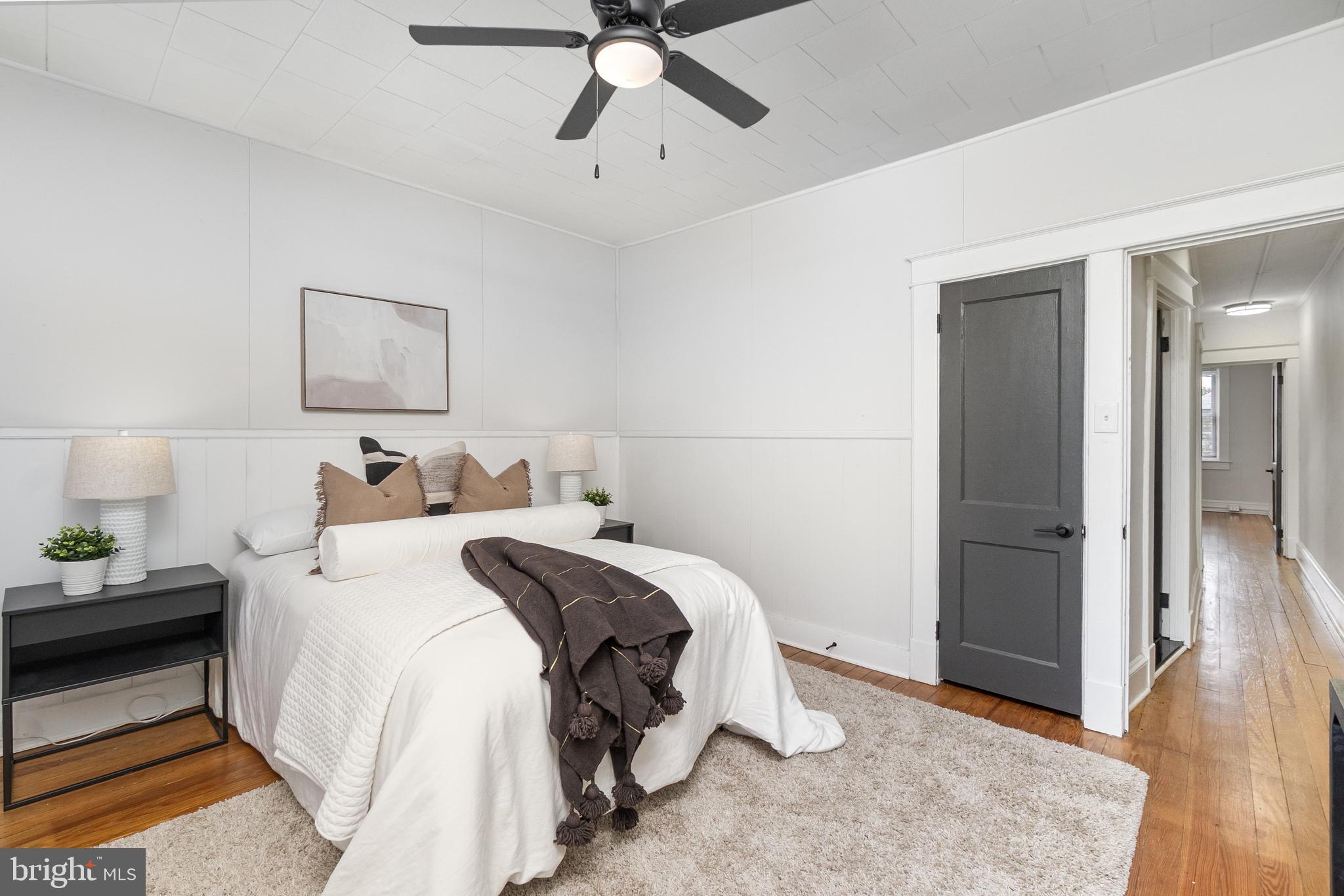 3822 6th Street Baltimore, MD 21225 - Photo 21 of 26 a bed room with a bed and a ceiling fan