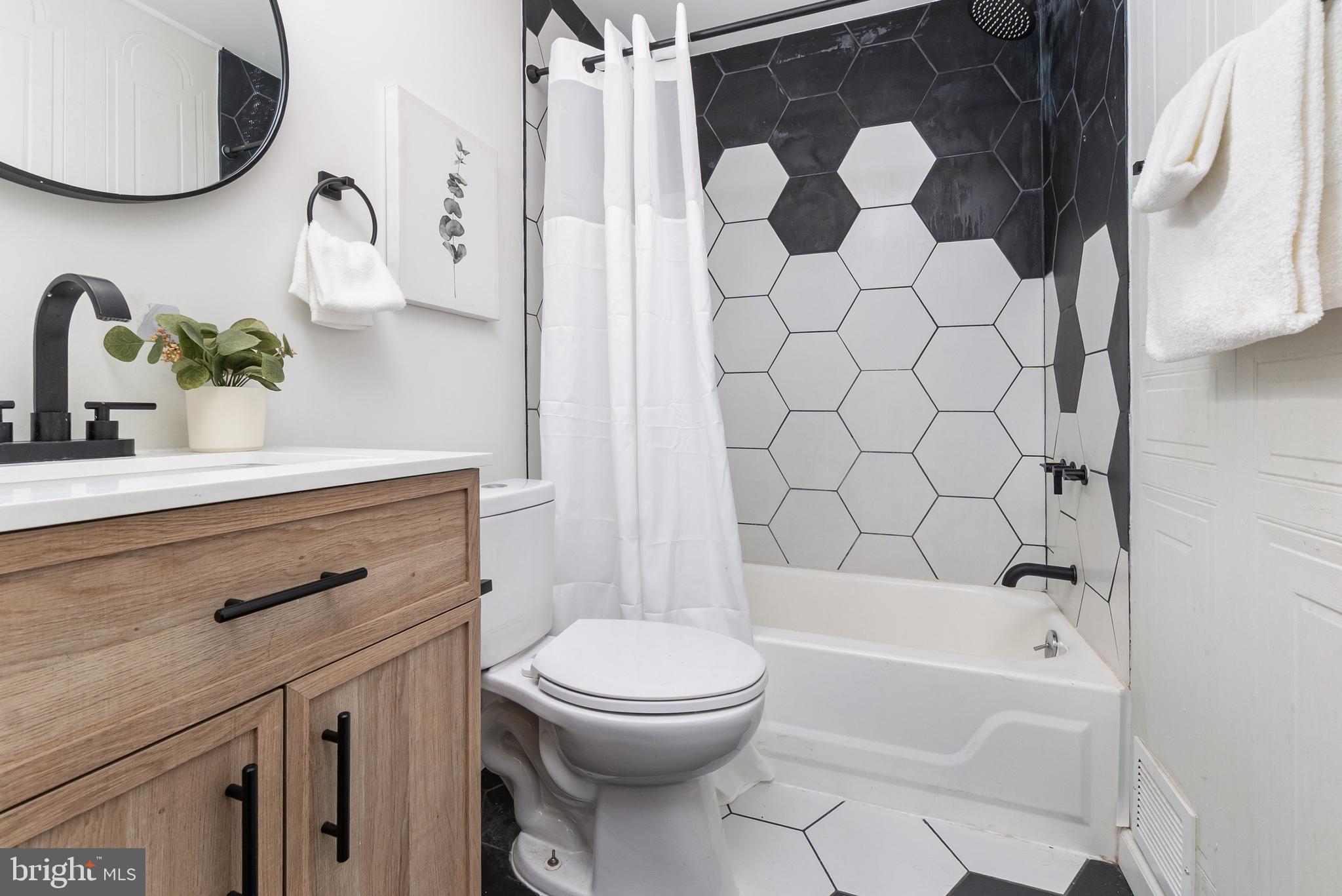 3822 6th Street Baltimore, MD 21225 - Photo 22 of 26 a bathroom with a sink a toilet and a bathtub