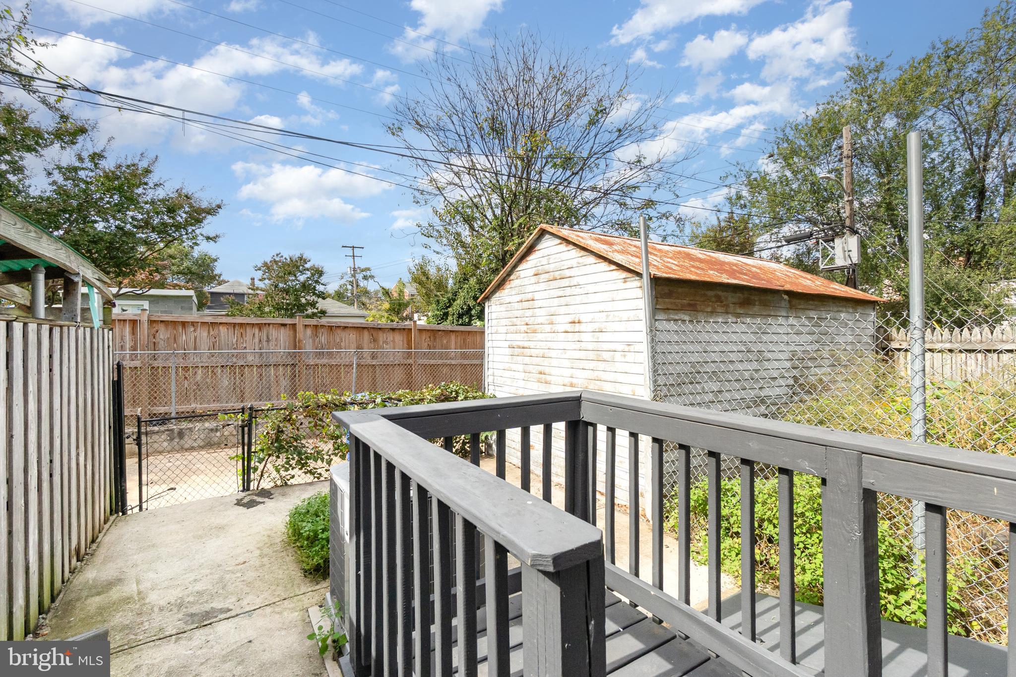 3822 6th Street Baltimore, MD 21225 - Photo 26 of 26 a view of a wooden deck and a yard