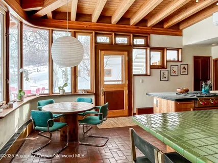 a bedroom with bed and a large window