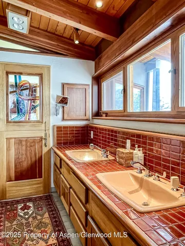 a living room with blue couches and painting on the wall