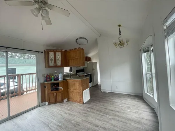 a view of a kitchen with furniture and wooden floor