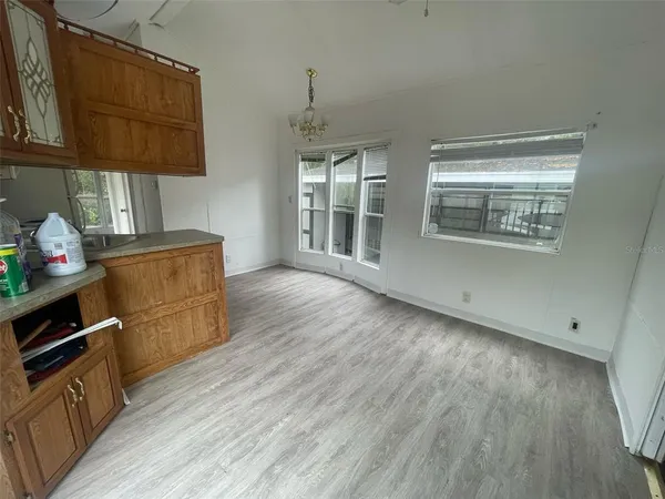 a kitchen with wooden floors and cabinets