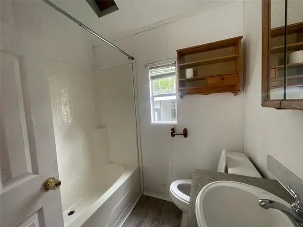 a bathroom with a sink a toilet and bathtub