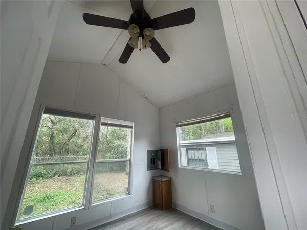 a view of a livingroom with a ceiling fan and window
