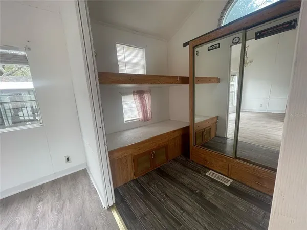 a bathroom with a glass door shower and a window