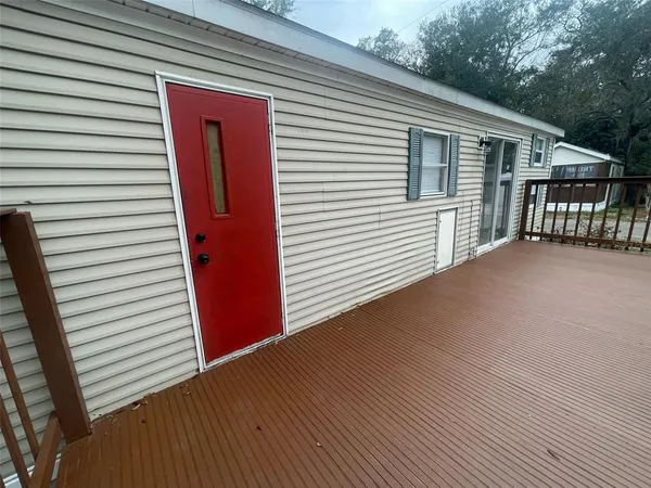 a view of backyard with deck and wooden floor