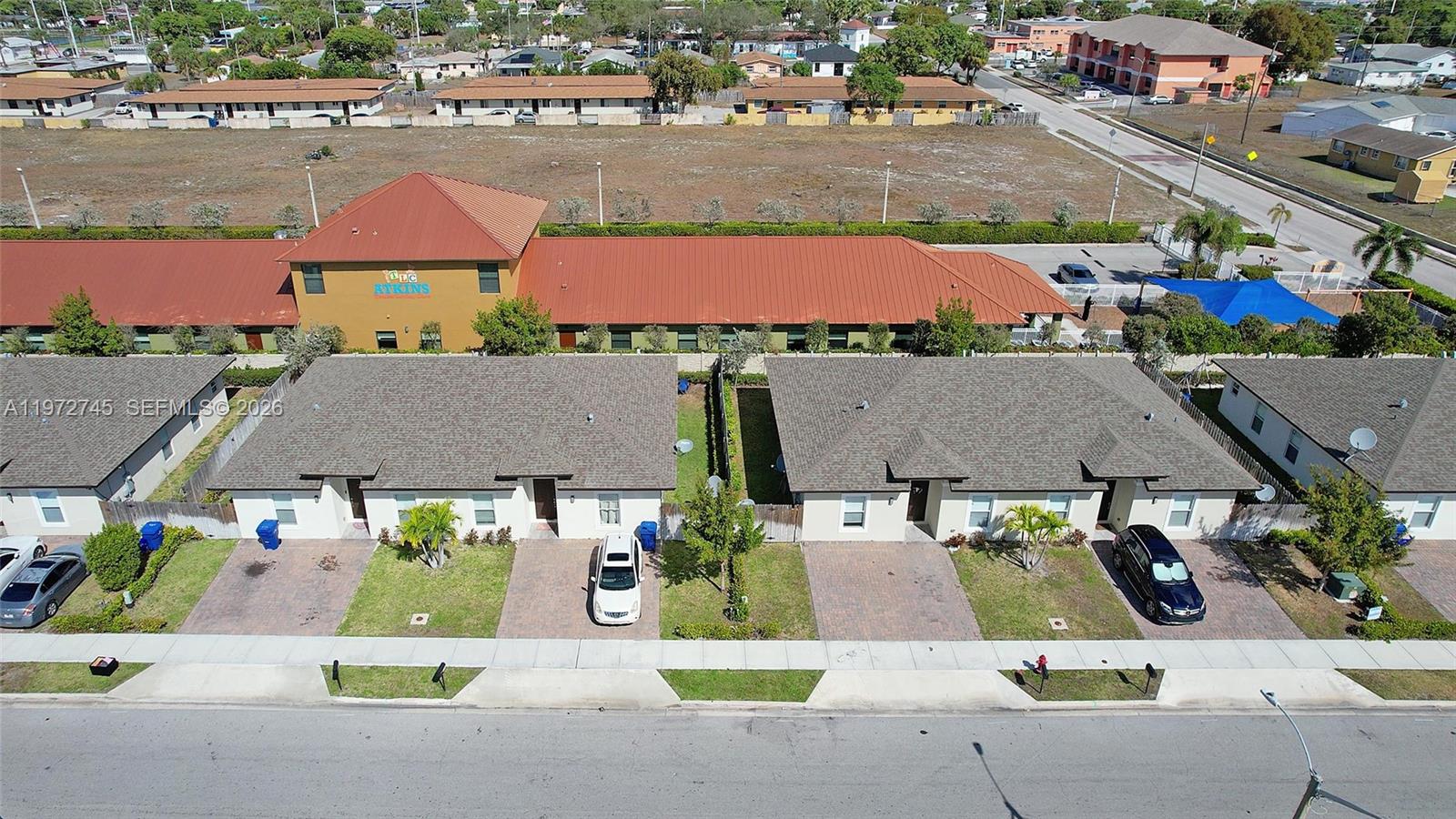 an aerial view of residential houses and outdoor space