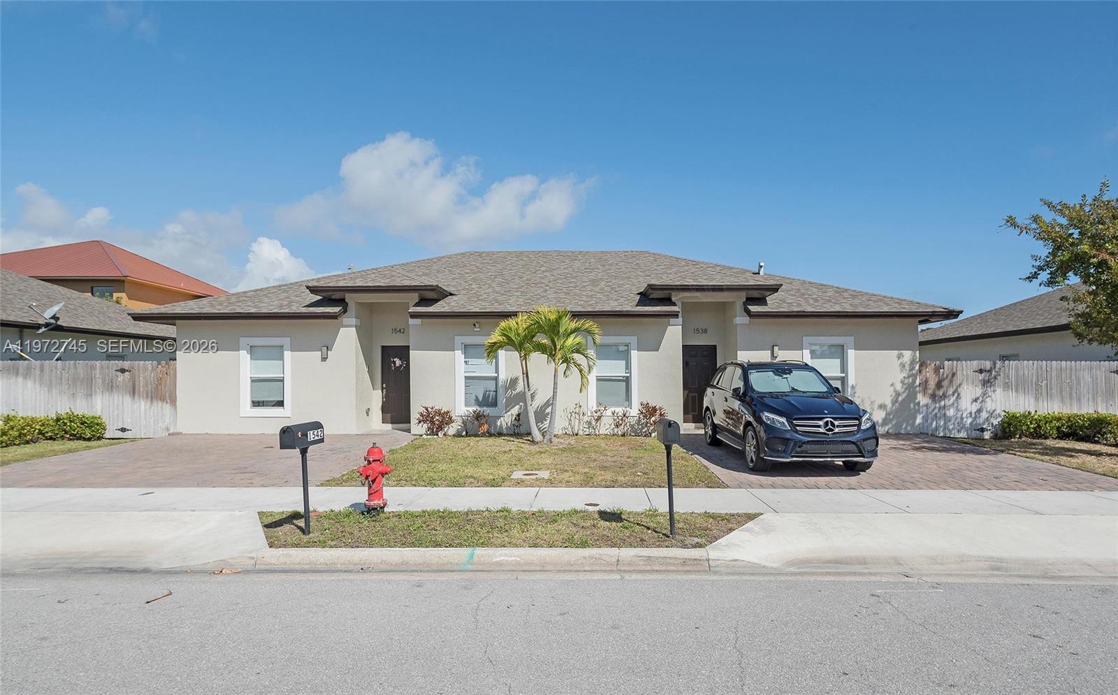 1538 West 26th Court Riviera Beach, FL 33404 - Photo 8 of 13 a view of a car park in front of garage