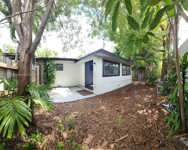 a view of a house with a tree in the background