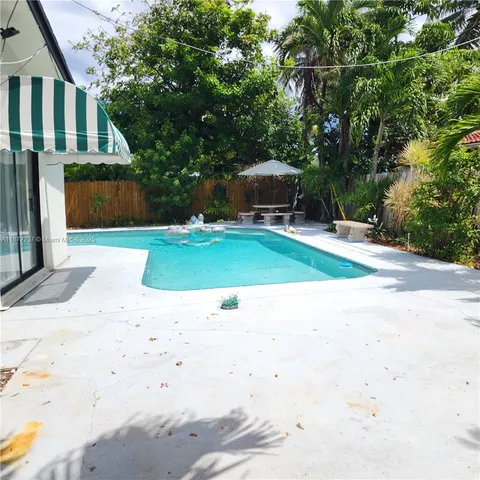 a small garden with tall trees