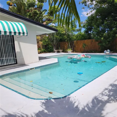 a view of a backyard with a small cabin and a chair