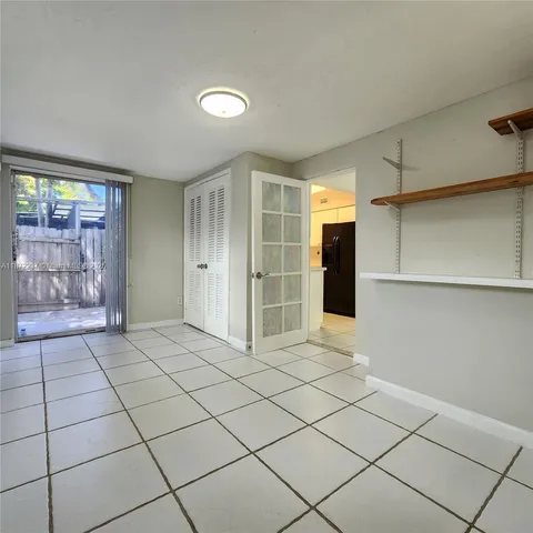 a view of empty room with window and chandelier