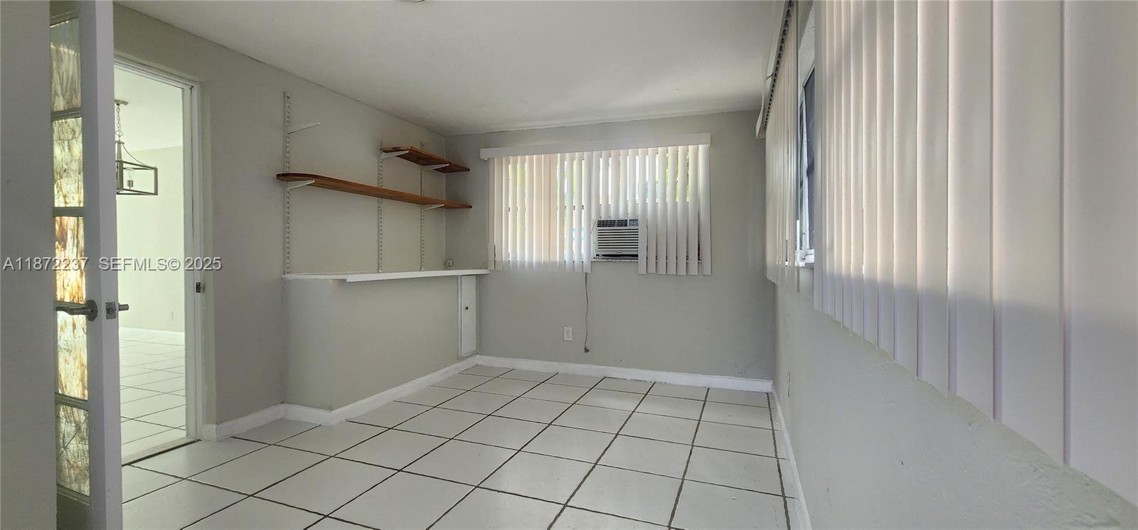 1940 Northeast 31st Court, Unit SOUTH Lighthouse Point, FL 33064 - Photo 22 of 45 a view of an empty room and window