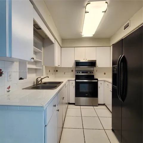a kitchen with a sink a stove and refrigerator