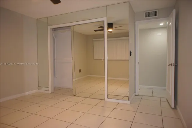 a bathroom with a shower and a glass door