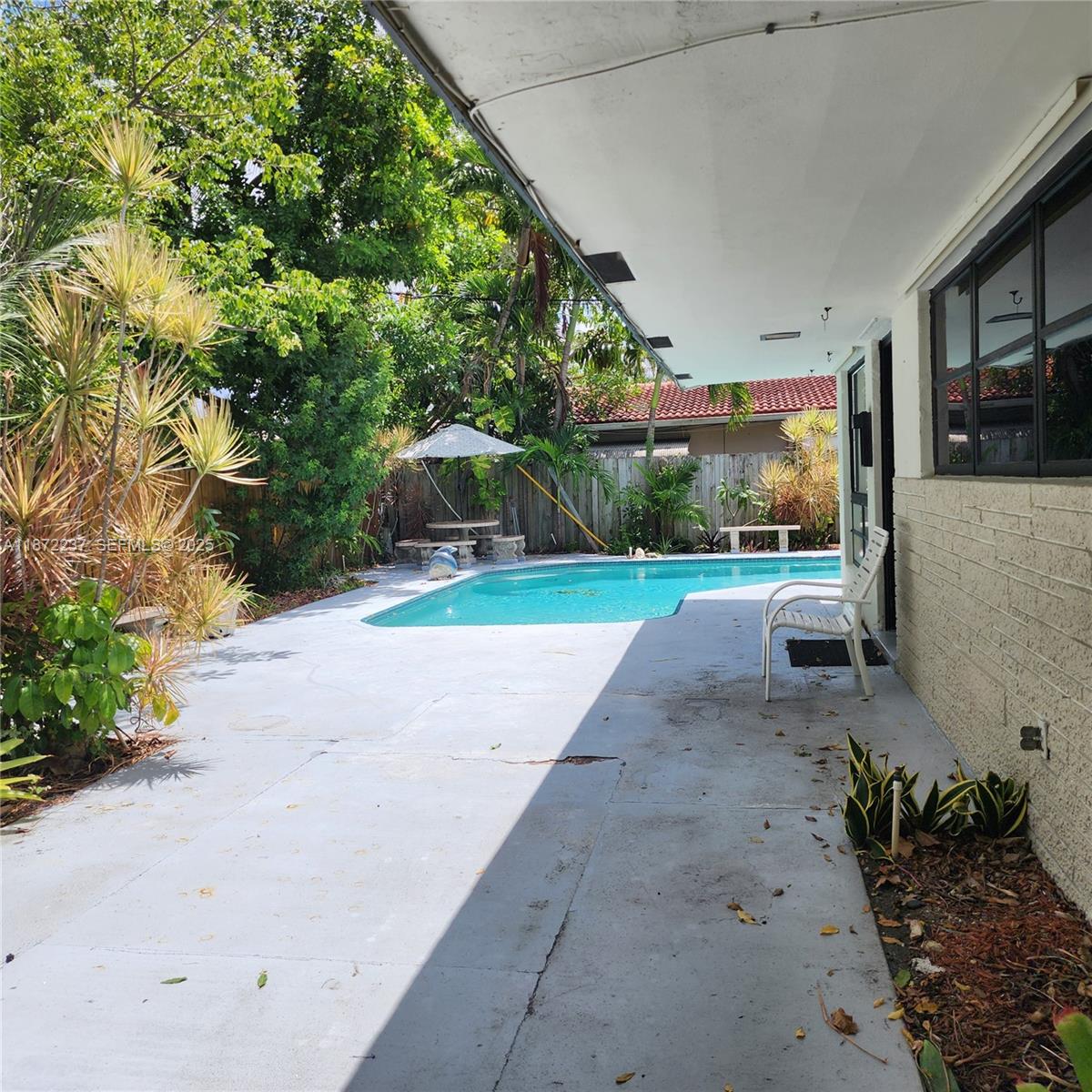 1940 Northeast 31st Court, Unit SOUTH Lighthouse Point, FL 33064 - Photo 4 of 45 a view of a back yard of the house