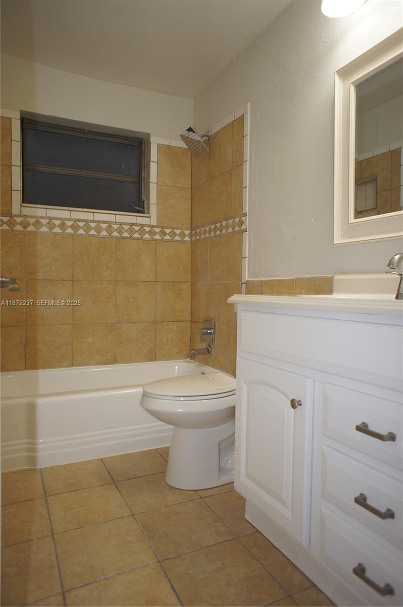 1940 Northeast 31st Court, Unit SOUTH Lighthouse Point, FL 33064 - Photo 42 of 45 a bathroom with a toilet a sink and bathtub