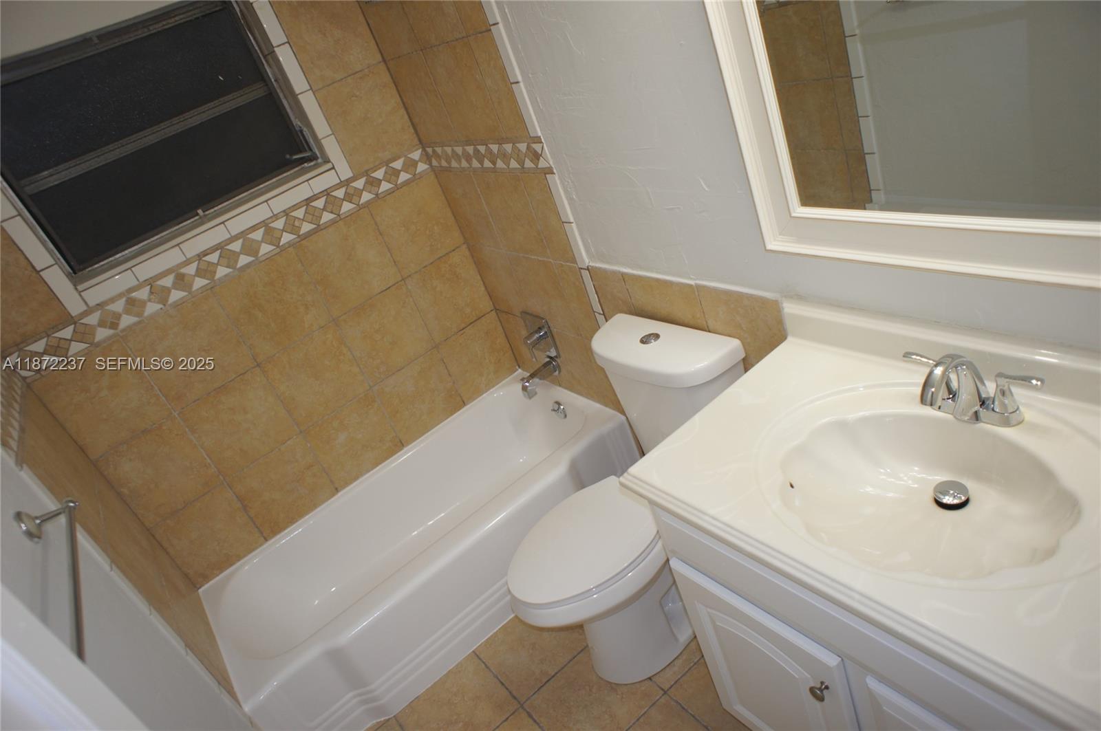 1940 Northeast 31st Court, Unit SOUTH Lighthouse Point, FL 33064 - Photo 43 of 45 a bathroom with a sink a toilet and a bathtub