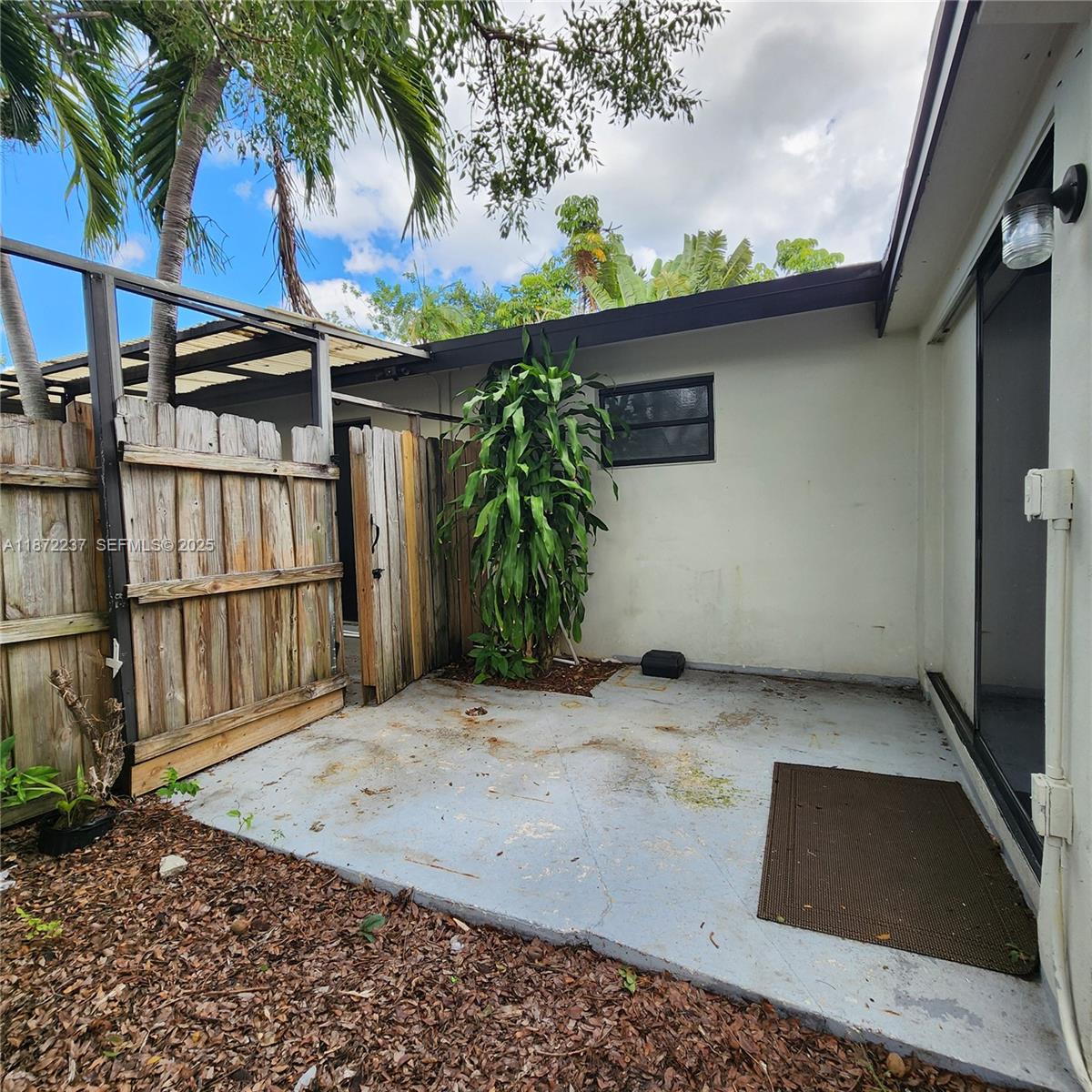 1940 Northeast 31st Court, Unit SOUTH Lighthouse Point, FL 33064 - Photo 10 of 45 a view of backyard with a potted plant