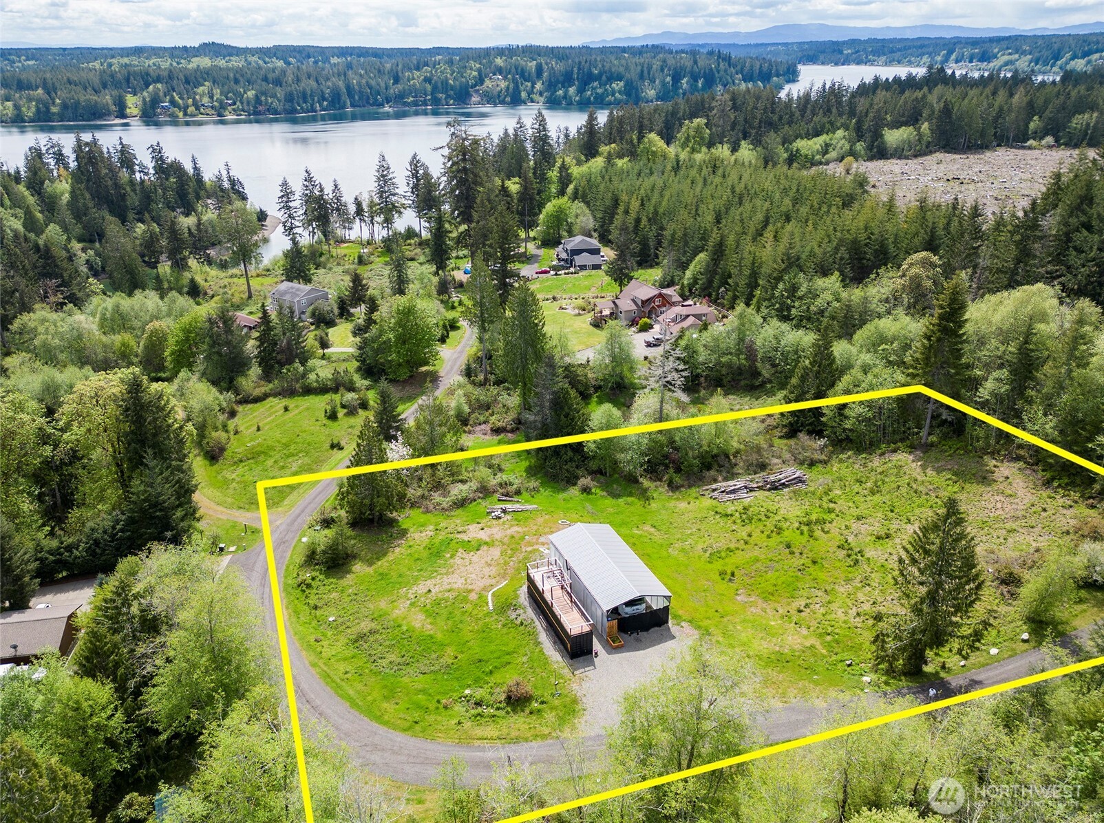 770 East April Avenue Grapeview, WA 98546 - Photo 6 of 16 a view of a swimming pool with a yard and plants
