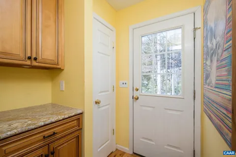 a view of a kitchen with wooden floor and windows