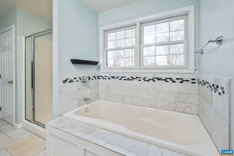 a white bath tub sitting next to a window