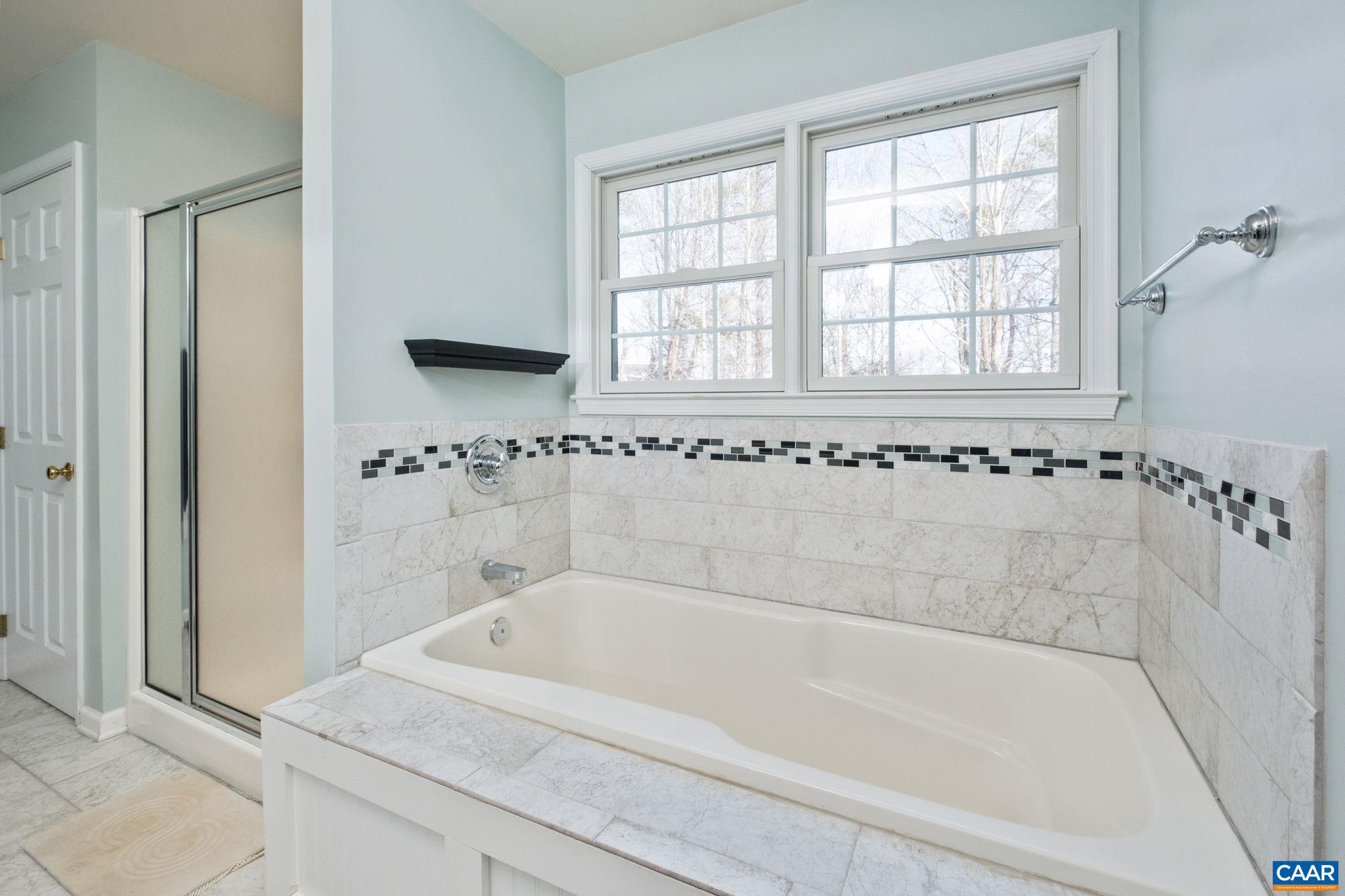 237 Spring Haven Lane Ruckersville, VA 22968 - Photo 19 of 41 a white bath tub sitting next to a window