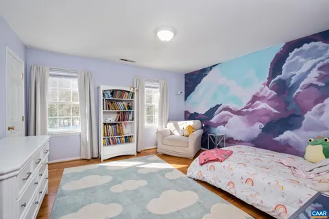 a bedroom with furniture and a book shelf