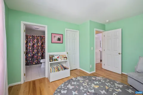 a view of a bedroom with bed and closet