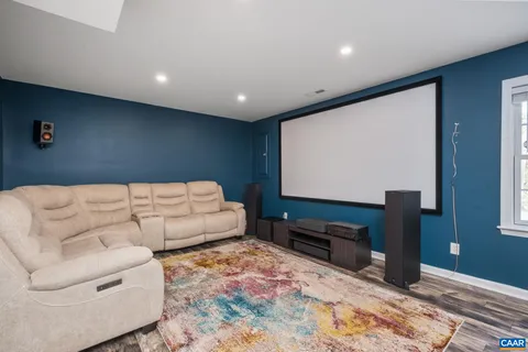 a living room with couches bookshelf