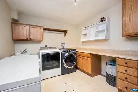 a utility room with sink dryer and washer