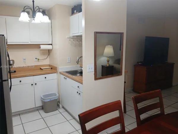 a kitchen with a sink cabinets and wooden floor