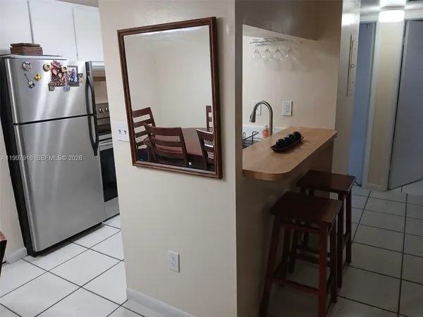 a kitchen with a refrigerator and a sink