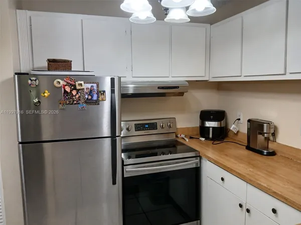 a kitchen with a refrigerator and a stove