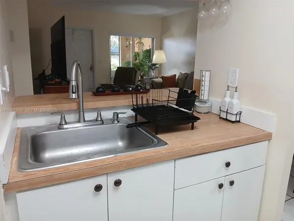 a kitchen with a sink and a mirror
