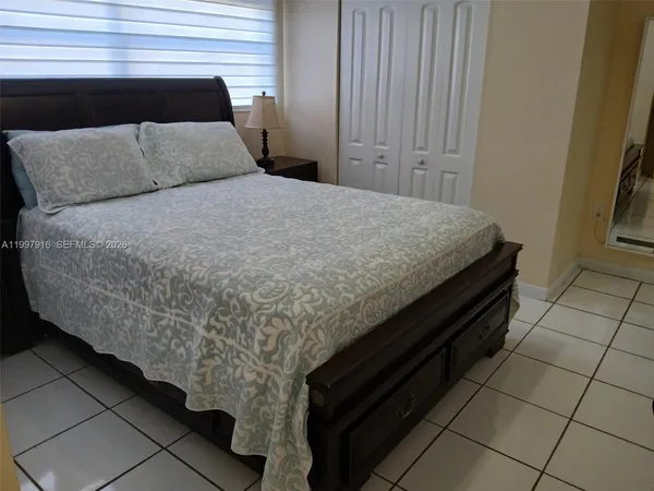 a bed sitting in a bedroom next to a window
