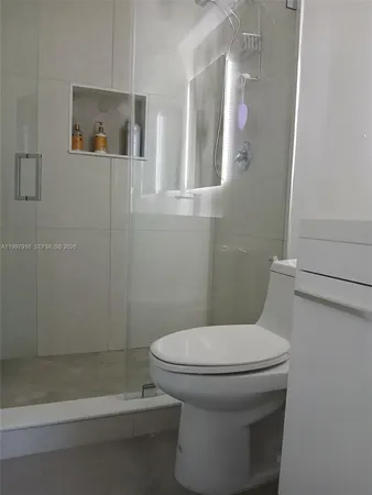 a bathroom with a toilet and a shower