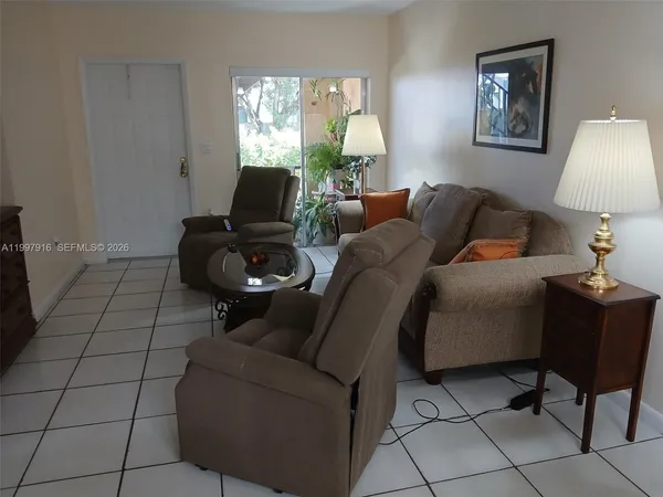 a living room with furniture and a lamp