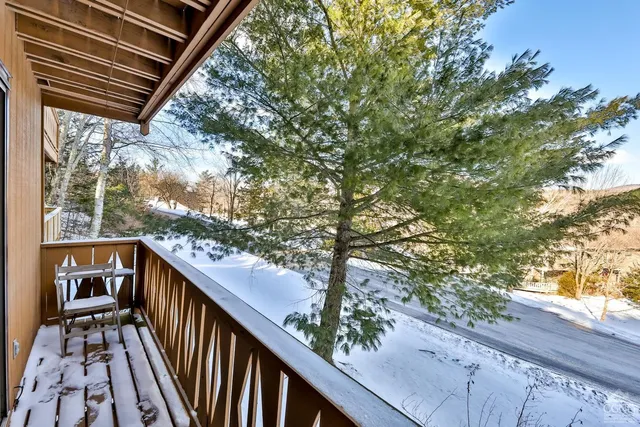 a balcony with wooden floor and outdoor space