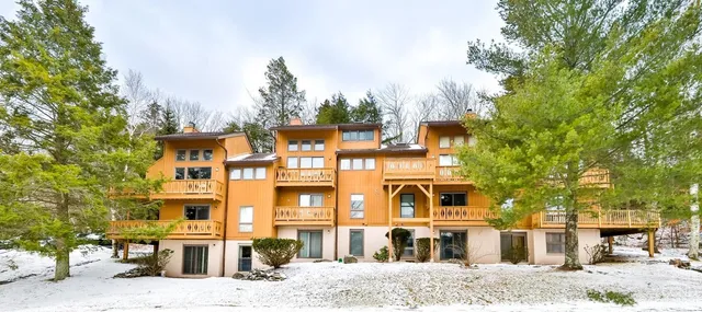 a front view of a residential apartment building with a yard