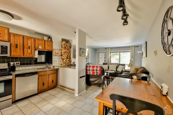 a kitchen that has a sink and a stove with white walls