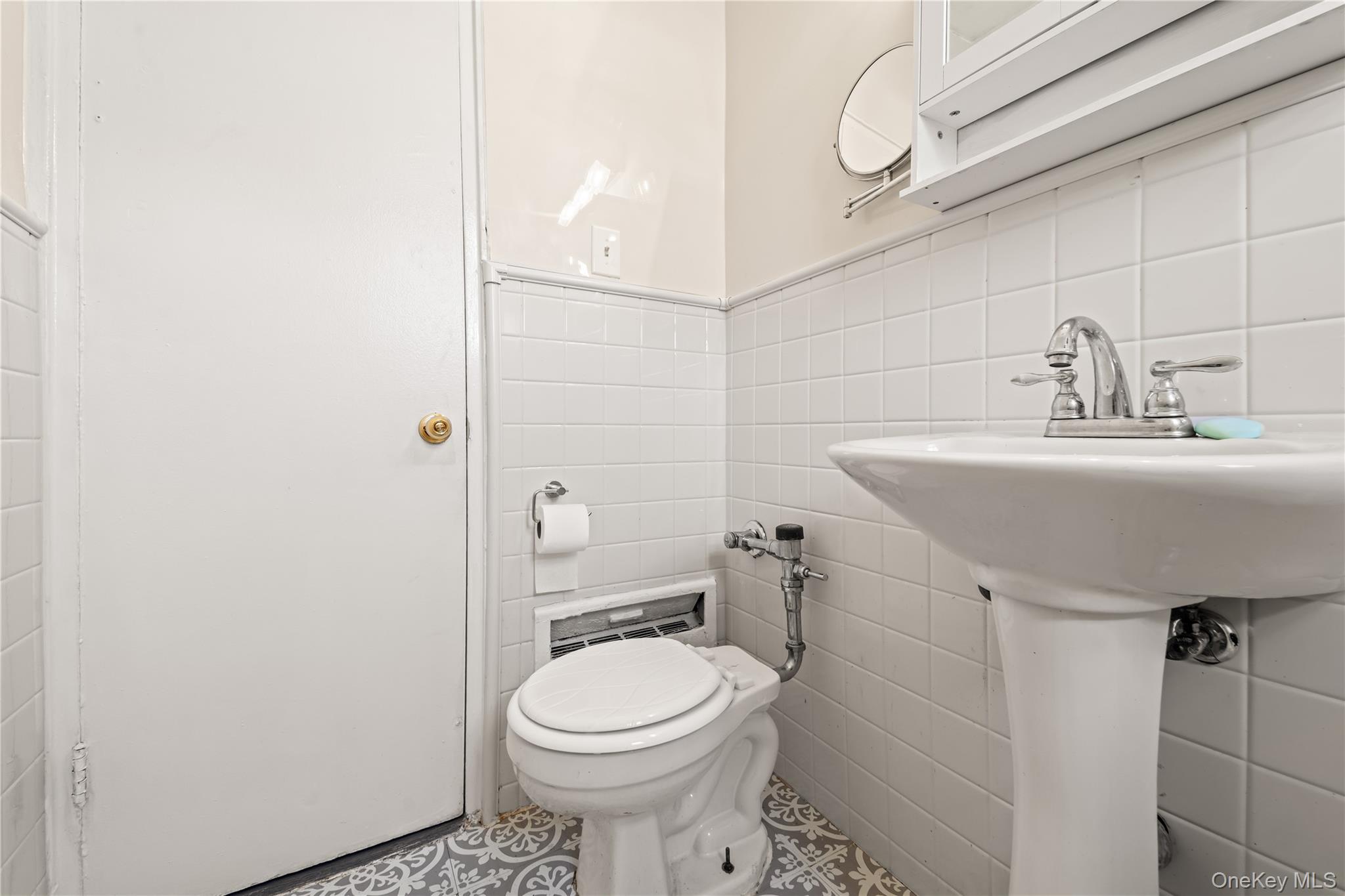 73-45 210th Street, Unit 3F Queens, NY 11364 - Photo 12 of 15 a bathroom with a sink toilet and shower